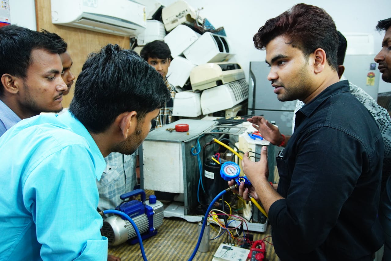 creative-03 Participants learn AC repair during a hands-on session in Delhi, India.