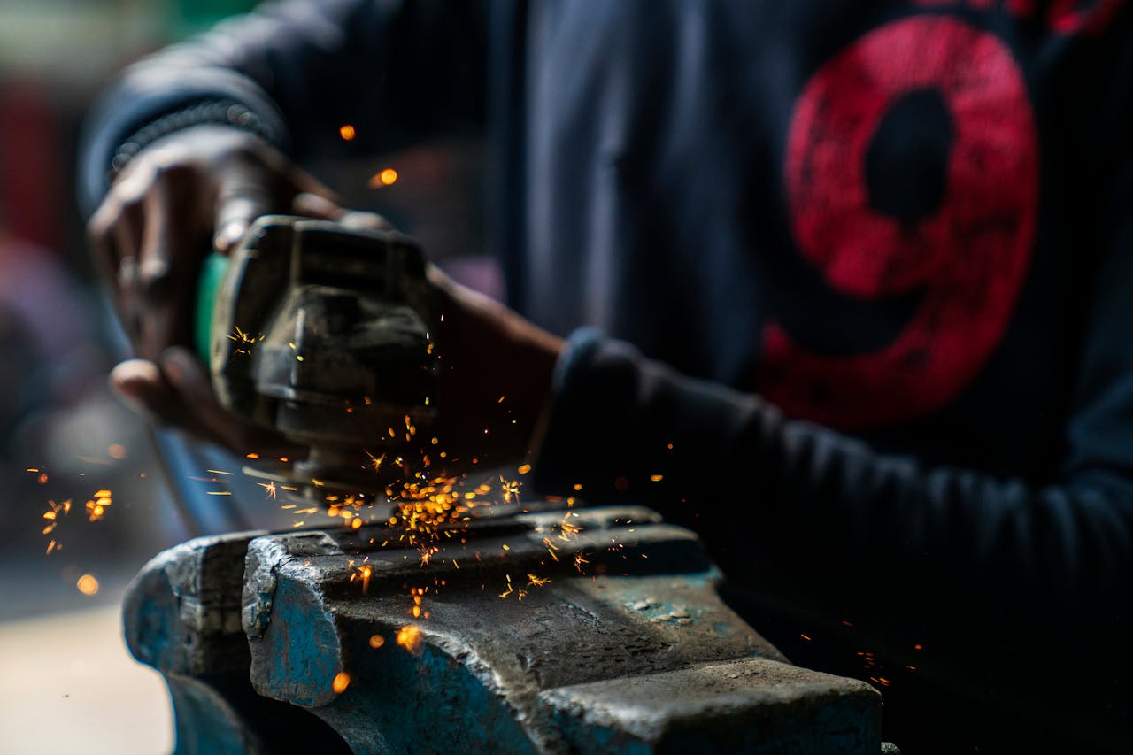 Crafting Captivating Headlines: Your awesome post title goes here Crop faceless professional African American craftsman wearing dirty clothes welding metal details in industrial workshop